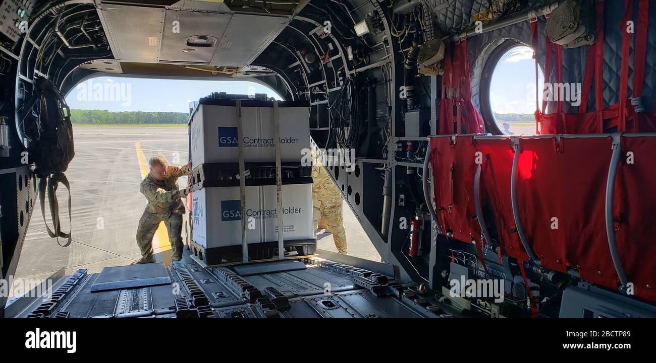 U.S. Army National Guard Soldiers with the South Carolina National Guard load personal protective equipment on a CH-47 Chinook assigned to the 2-238th General Support Aviation Battalion, South Carolina National Guard, to be transported and distributed to counties in the upstate of South Carolina in support of the South Carolina Department of Health and Environmental Control. The South Carolina National Guard remains ready to support the counties, local and state agencies, and first responders with requested resources for as long as needed in support of COVID-19 response efforts in the state. ( Stock Photo