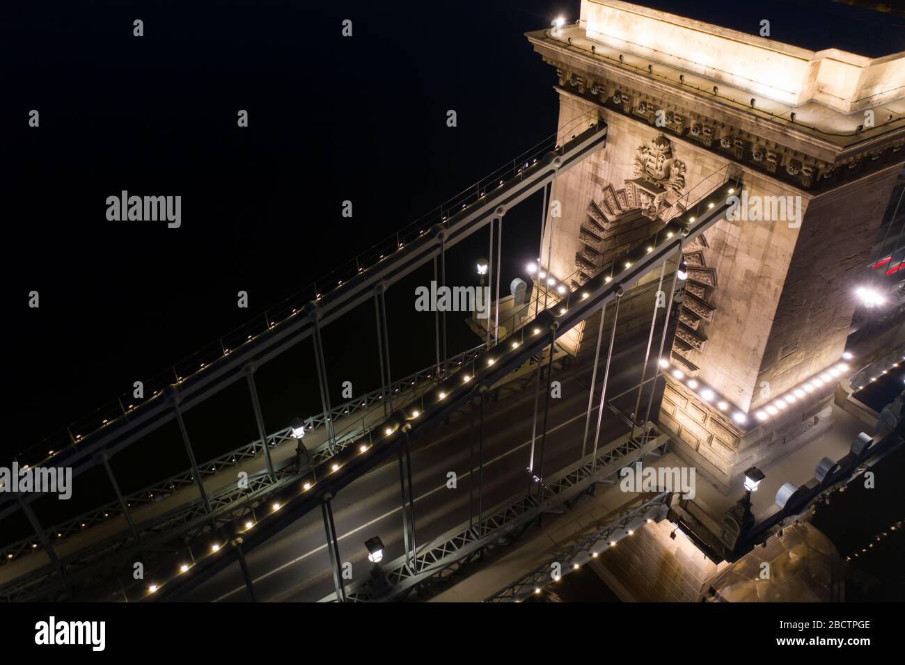 Hungarian Crest on illuminated Chain Bridge, Budapest, Hungary. Close up aerial stock photo. Stock Photo