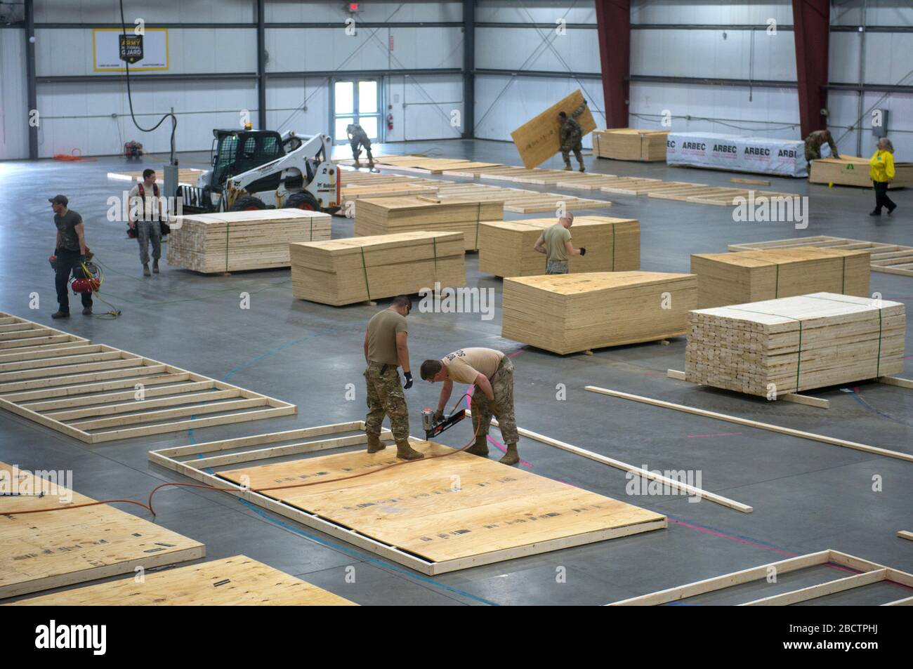 Airmen and soldiers from the Vermont National Guard work to construct a 400-bed medical surge facility at the Champlain Valley Exposition, Essex Junction, Vermont, April 04, 2020. The Vermont National Guard is working with the state of Vermont and emergency response partners in a whole-of-government effort to flatten the curve during the COVID-19 pandemic. (U.S. Air National Guard photo by Miss Julie M. Shea) Stock Photo