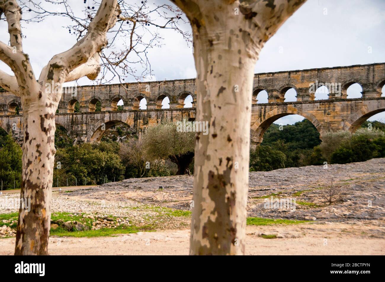 Pont du Gard in Southern France is an ancient Roman aqueduct that crosses the Gardon River bringing water to Nîmes. Stock Photo