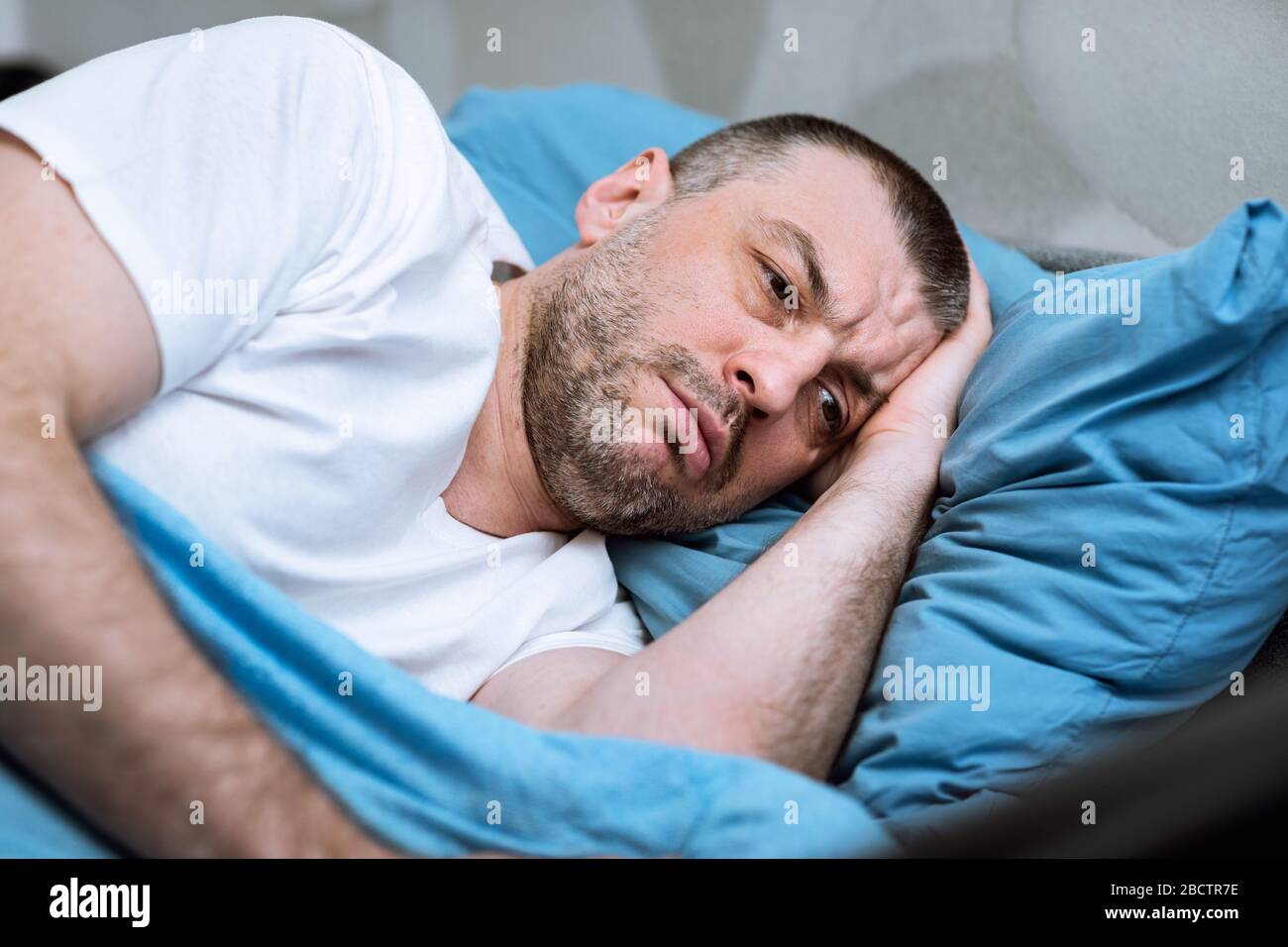 Mature Man Lying In Bed Unable To Sleep At Home Stock Photo - Alamy