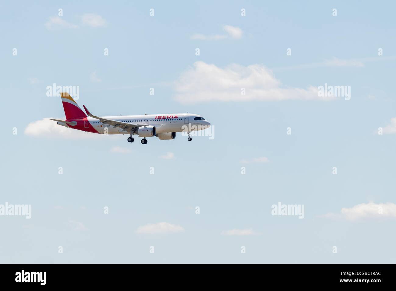 MADRID, SPAIN - APRIL 14, 2019: Iberia Airlines Airbus A320 passenger plane ready to land at Madrid-Barajas International Airport Adolfo Suárez, on a Stock Photo