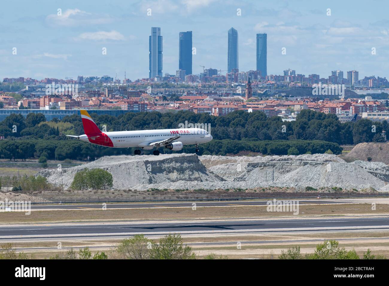 MADRID, SPAIN - APRIL 14, 2019: Iberia Airlines Airbus A320 passenger plane landing at Madrid-Barajas International Airport Adolfo Suarez In the backg Stock Photo