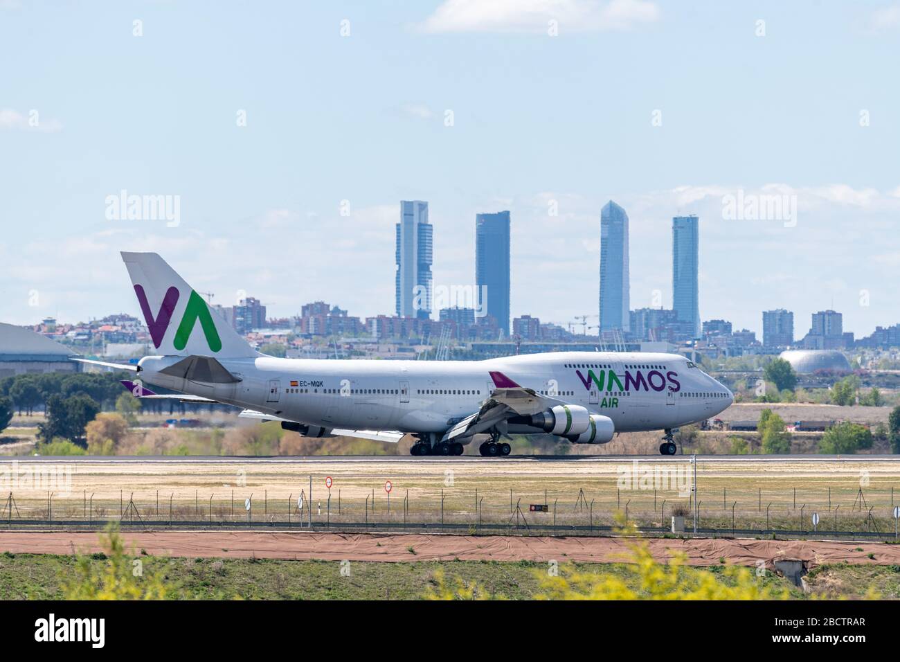 MADRID, SPAIN - APRIL 14, 2019: VAMOS Airlines Boeing 747 passenger plane landing at Madrid-Barajas International Airport Adolfo Suarez In the backgro Stock Photo