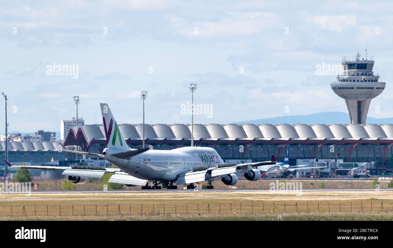 MADRID, SPAIN - APRIL 14, 2019: VAMOS Airlines Boeing 747 passenger plane landing at Madrid-Barajas International Airport Adolfo Suarez . Stock Photo
