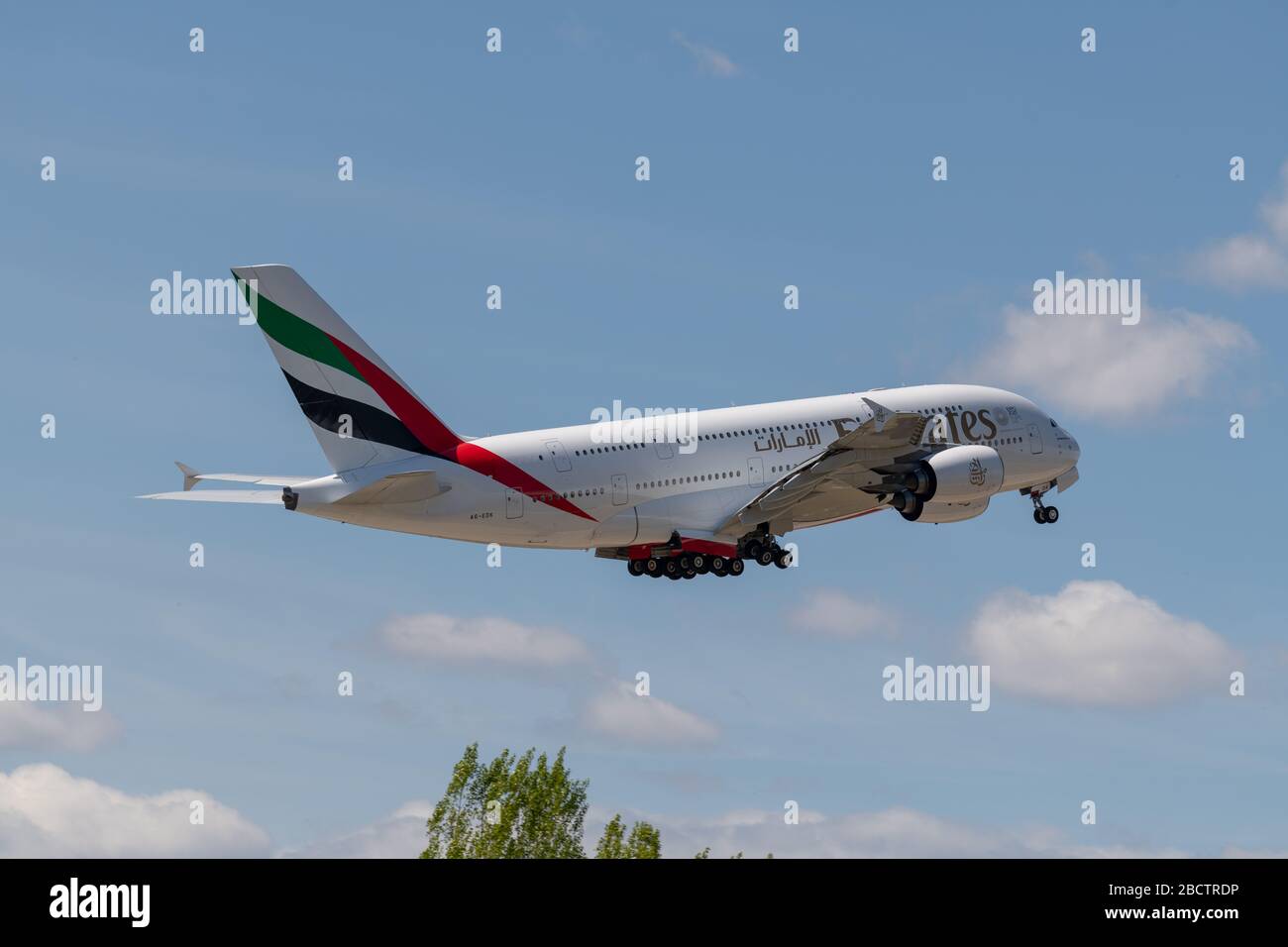 MADRID, SPAIN - 14 APRIL 2019: Emirates Airbus A380 passenger plane takes off from the Adolfo Suarez International Airport of Madrid-Barajas, in a blu Stock Photo