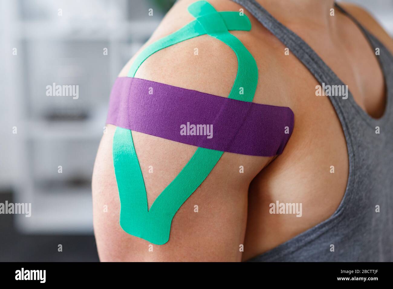 Kinesiology taping. Kinesiology tape on patient shoulder. Injured shoulder  treatment of young male athlete. Post traumatic rehabilitation, sport Stock  Photo - Alamy