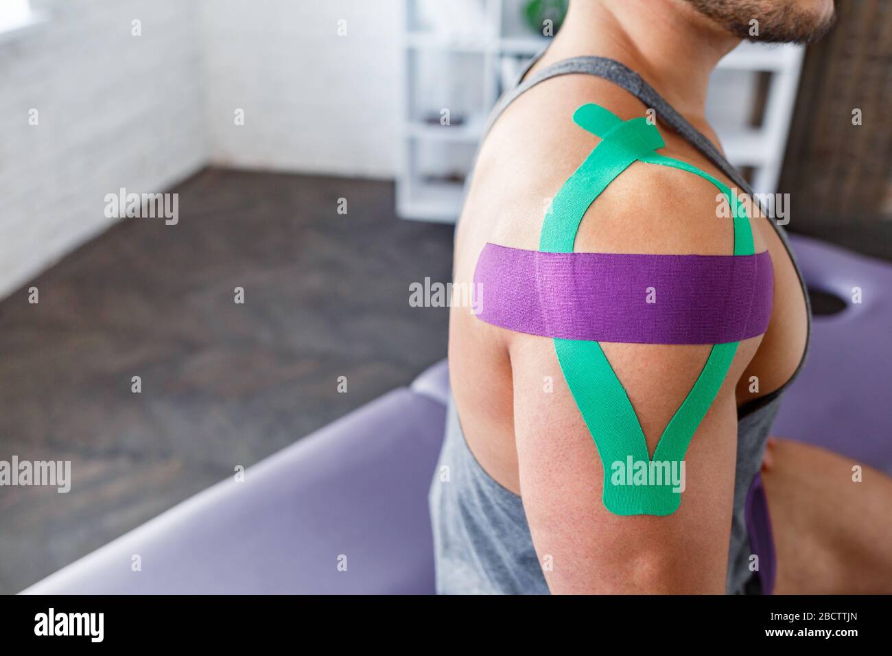 Kinesiology taping. Kinesiology tape on patient shoulder. Injured shoulder  treatment of young male athlete. Post traumatic rehabilitation, sport Stock  Photo - Alamy
