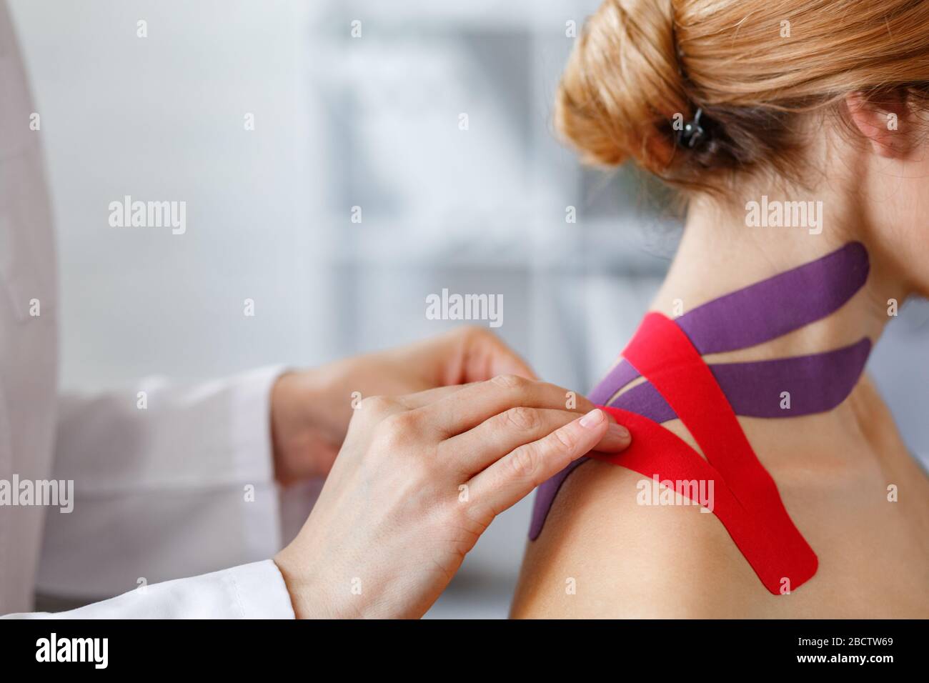 Kinesiology taping. Physical therapist applying kinesiology tape to