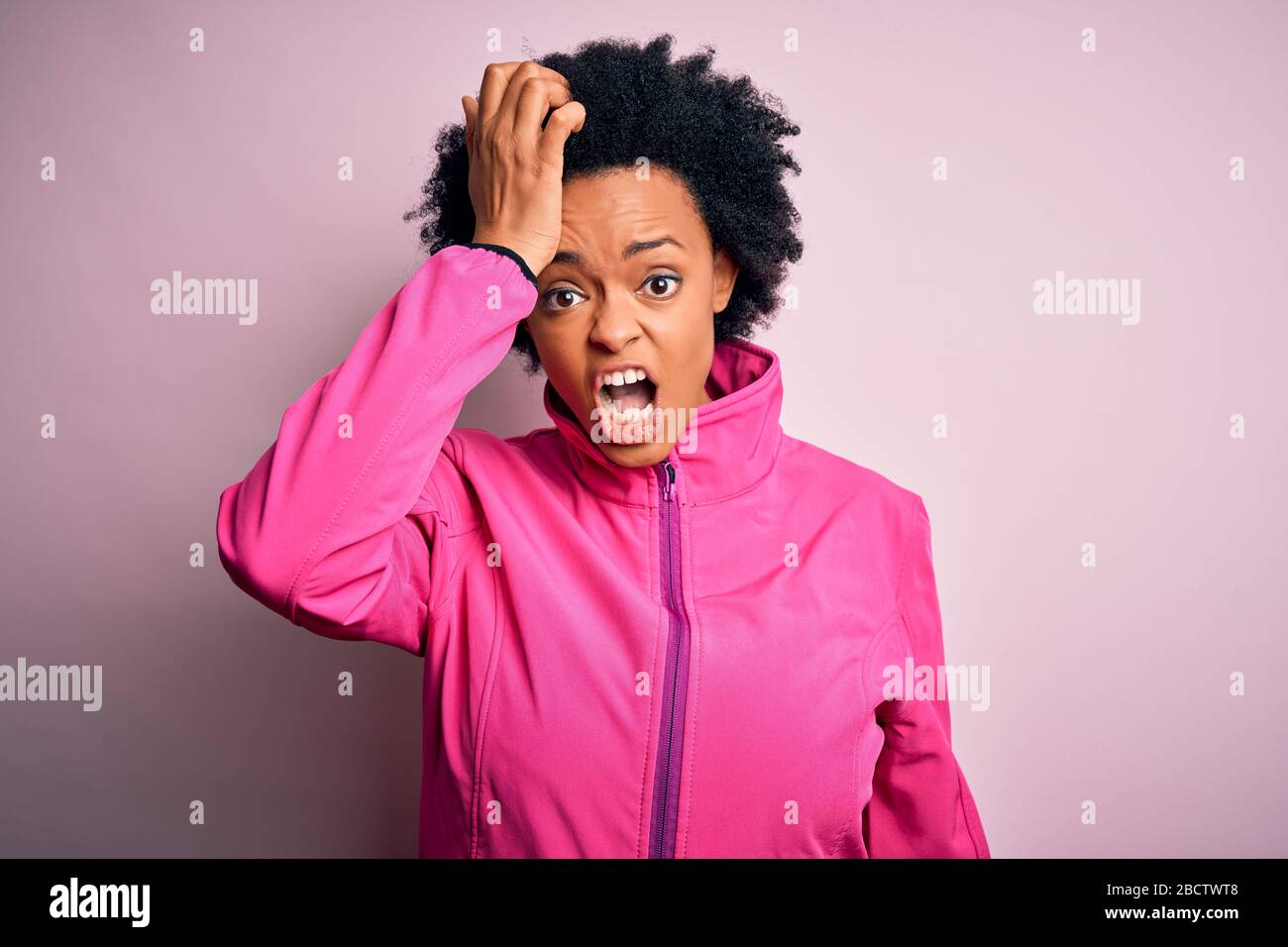 Young African American afro sportswoman with curly hair wearing