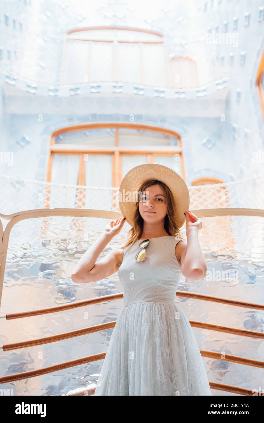 Portrait of a female tourist from the Casa Batllo by Antonio Gaudi in the background on a summer day Stock Photo