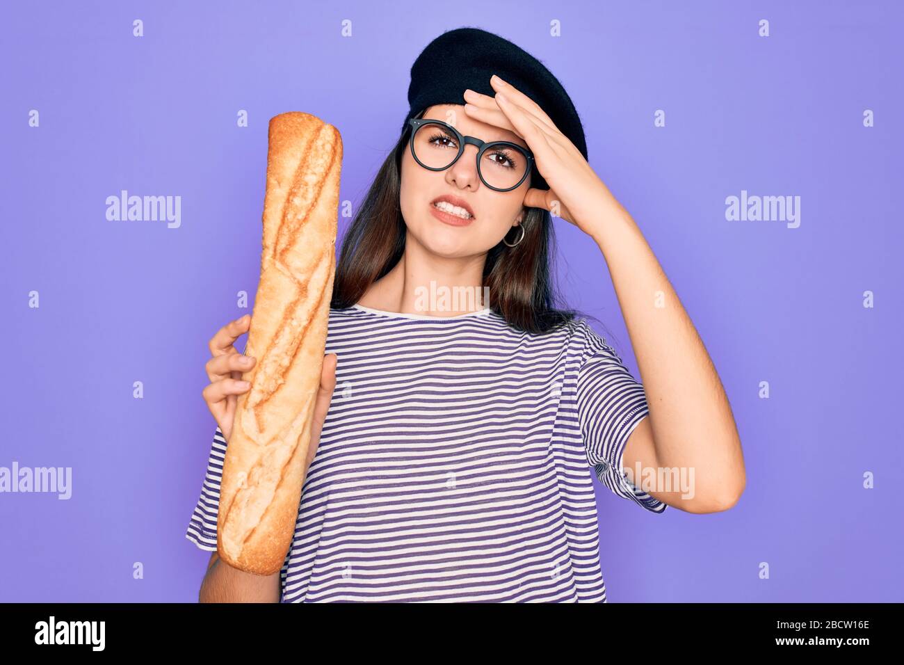 Young beautiful girl wearing fashion french beret holding fresh