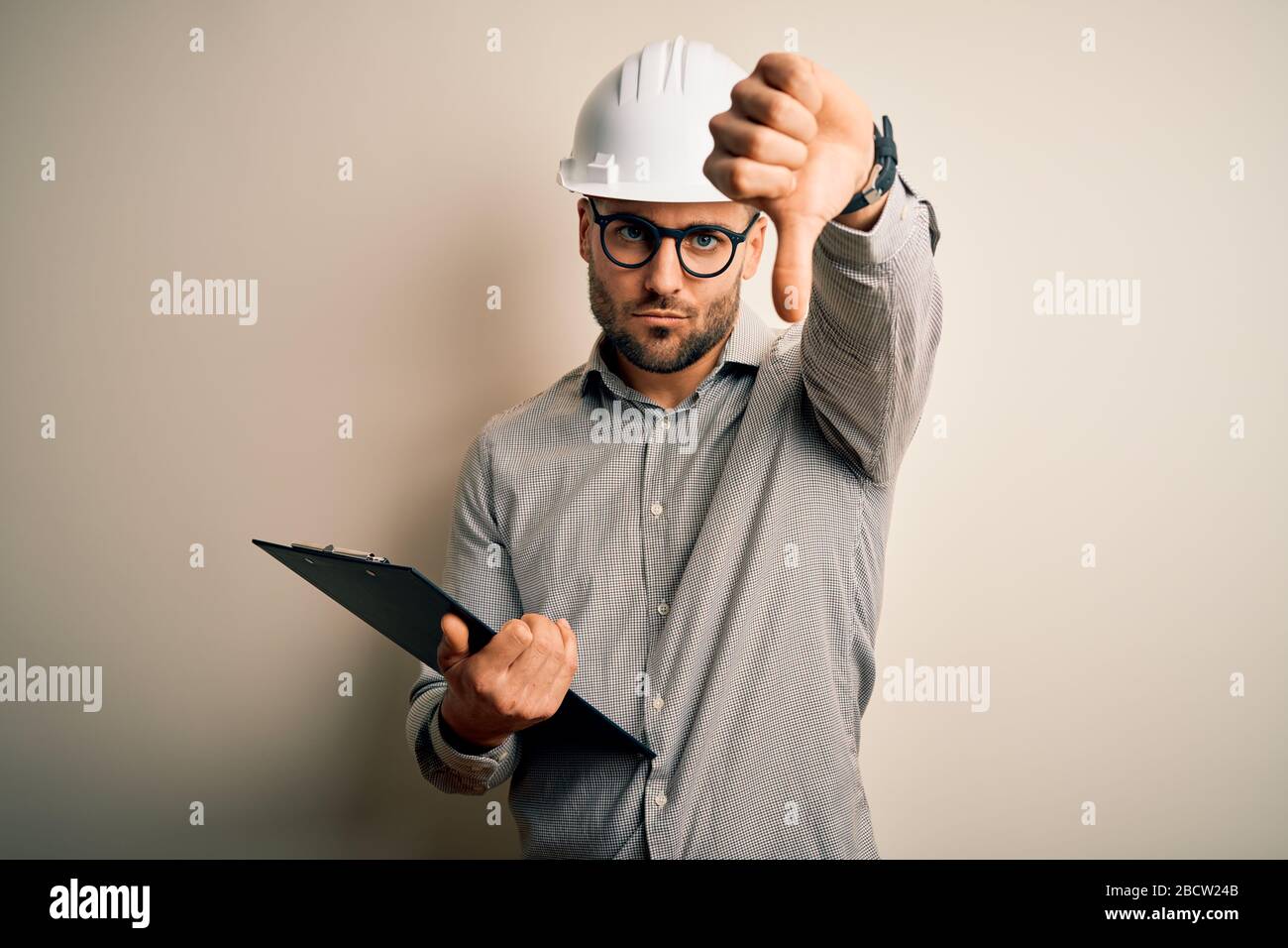 Young architect inspector man wearing builder safety helmet and using ...