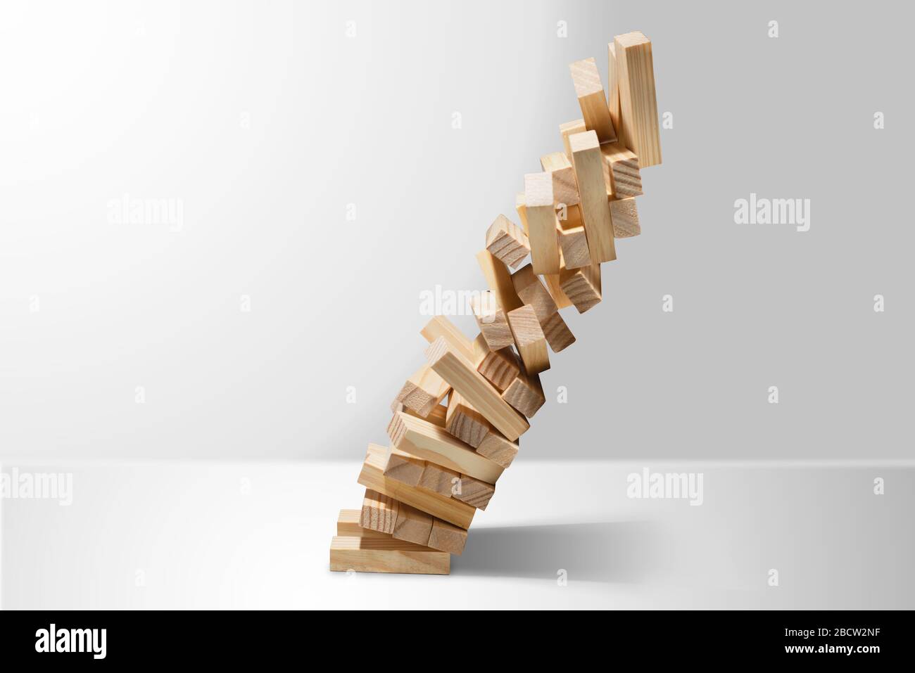 Wooden block tower game collapses isolated on white background with copy space Stock Photo