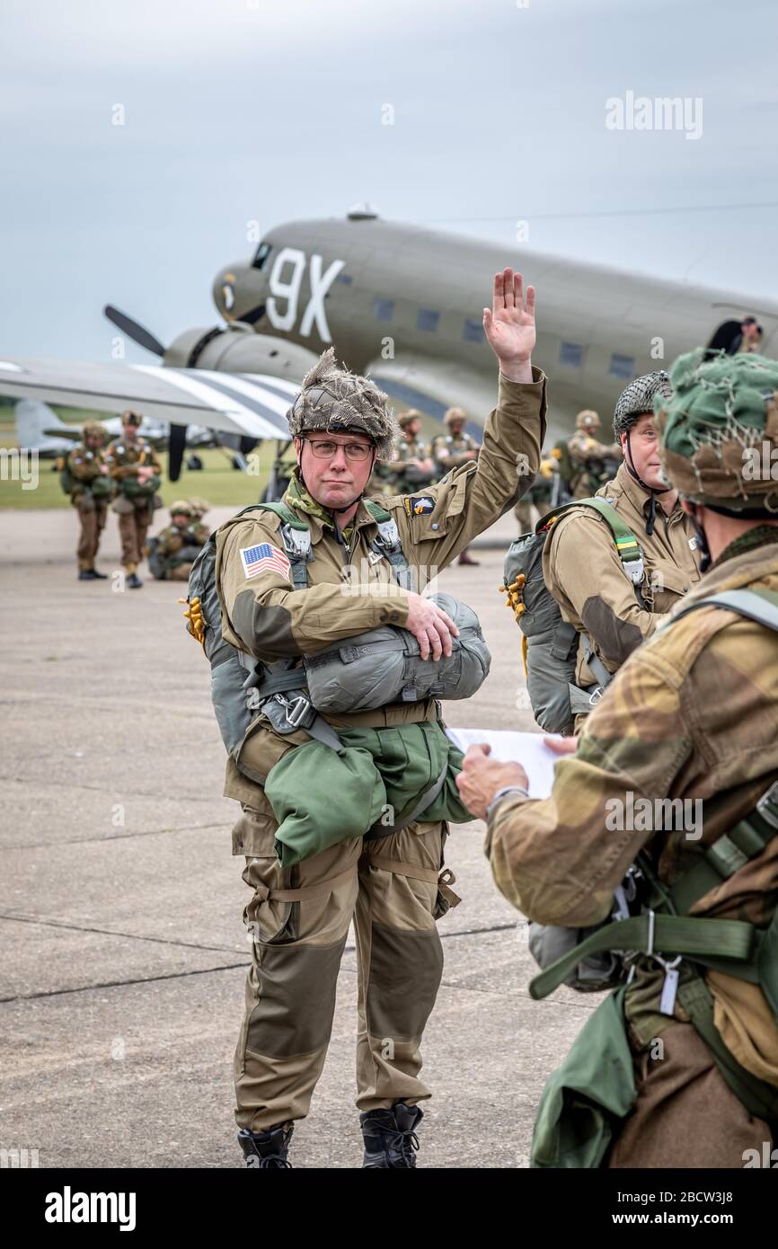 Paratroopers and C-47A Douglas Dakota during the Daks over Normandy event, Duxford Airfield, Cambridgeshire, UK Stock Photo