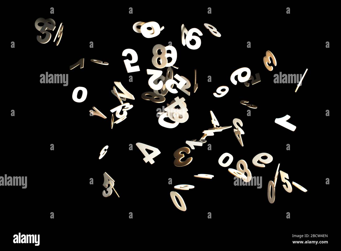 Real Wood Numbers Flying away Isolated on Black Background Stock Photo