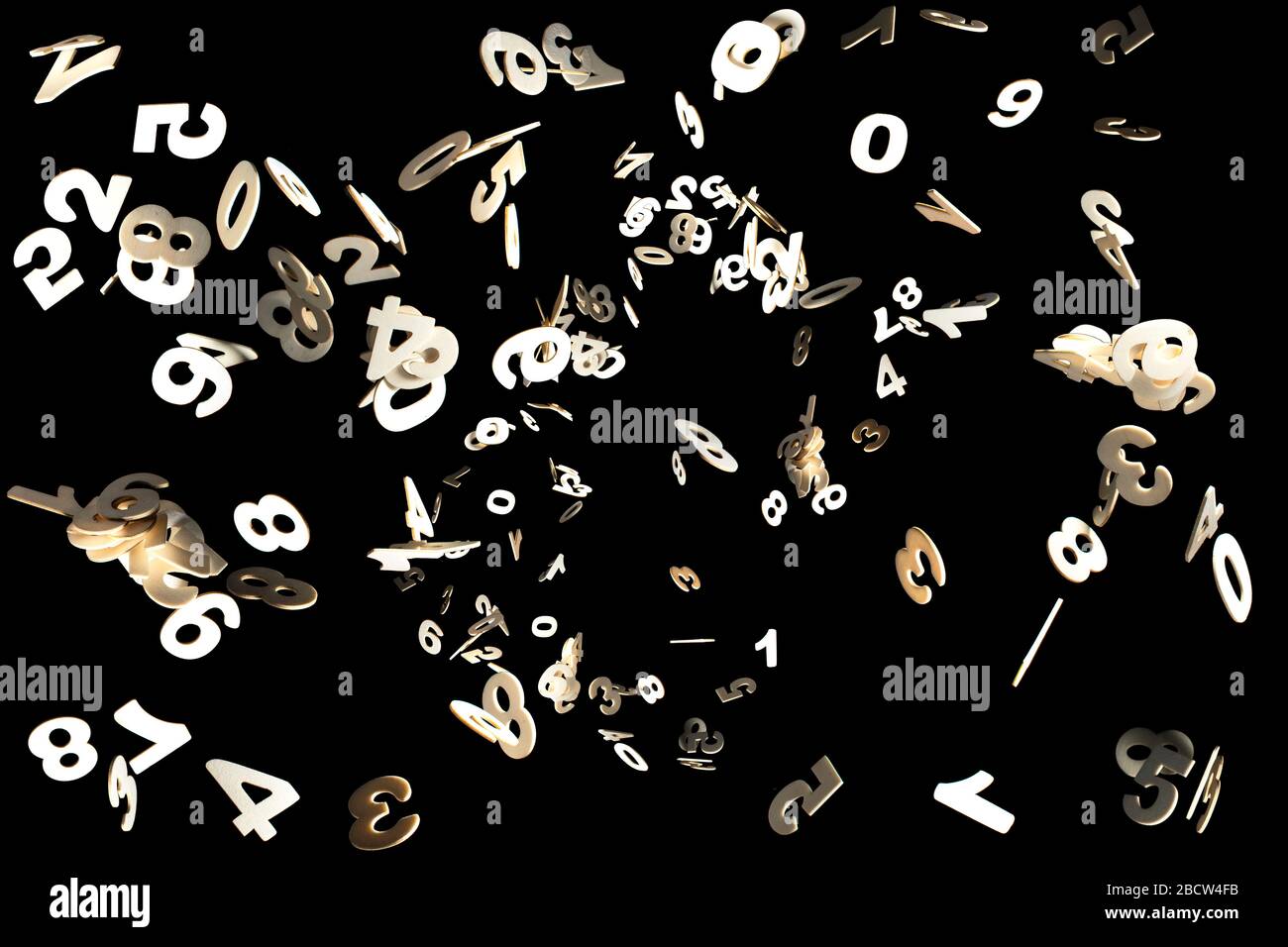 Real Wood Numbers Flying away Isolated on Black Background Stock Photo