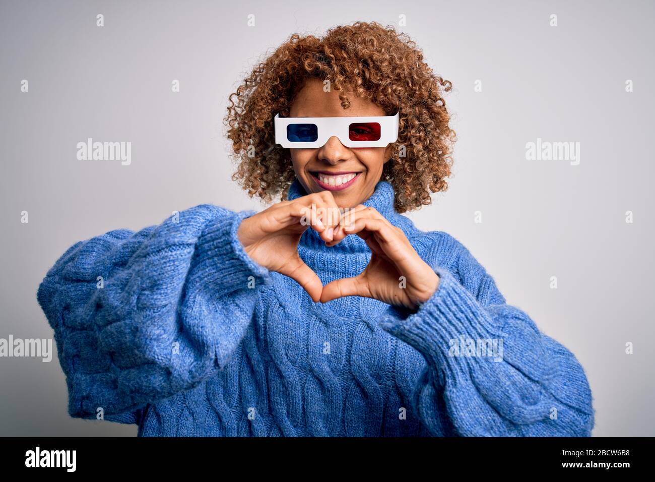 Young african american curly woman wearing 3d glasses over isolated ...