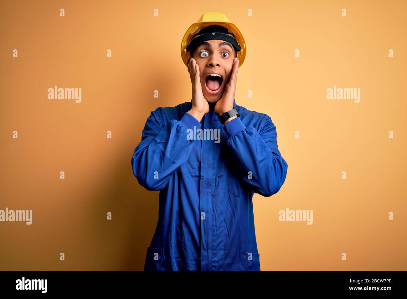 Young handsome african american worker man wearing blue uniform and ...
