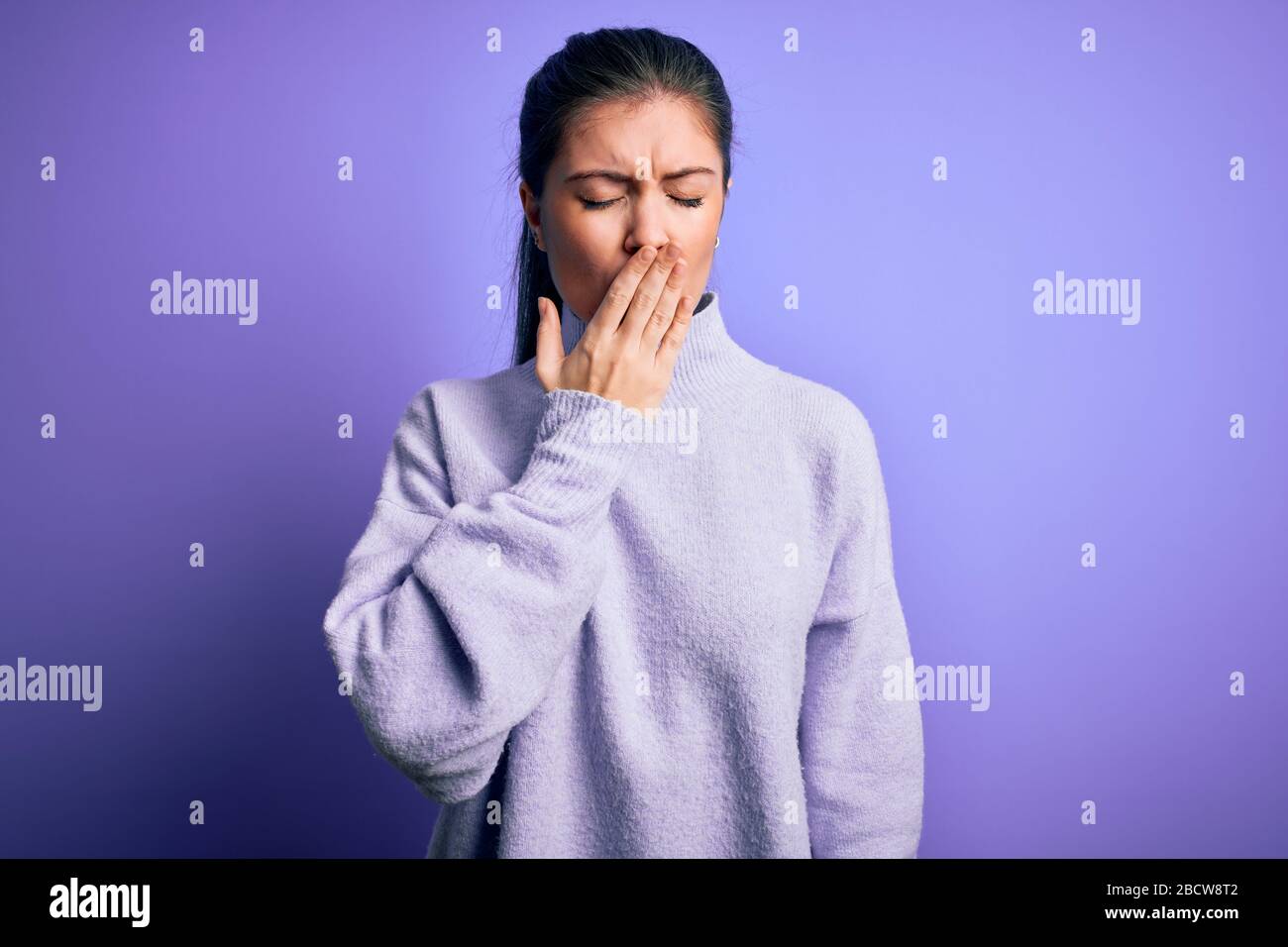 Young beautiful woman with blue eyes wearing casual turtleneck sweater ...