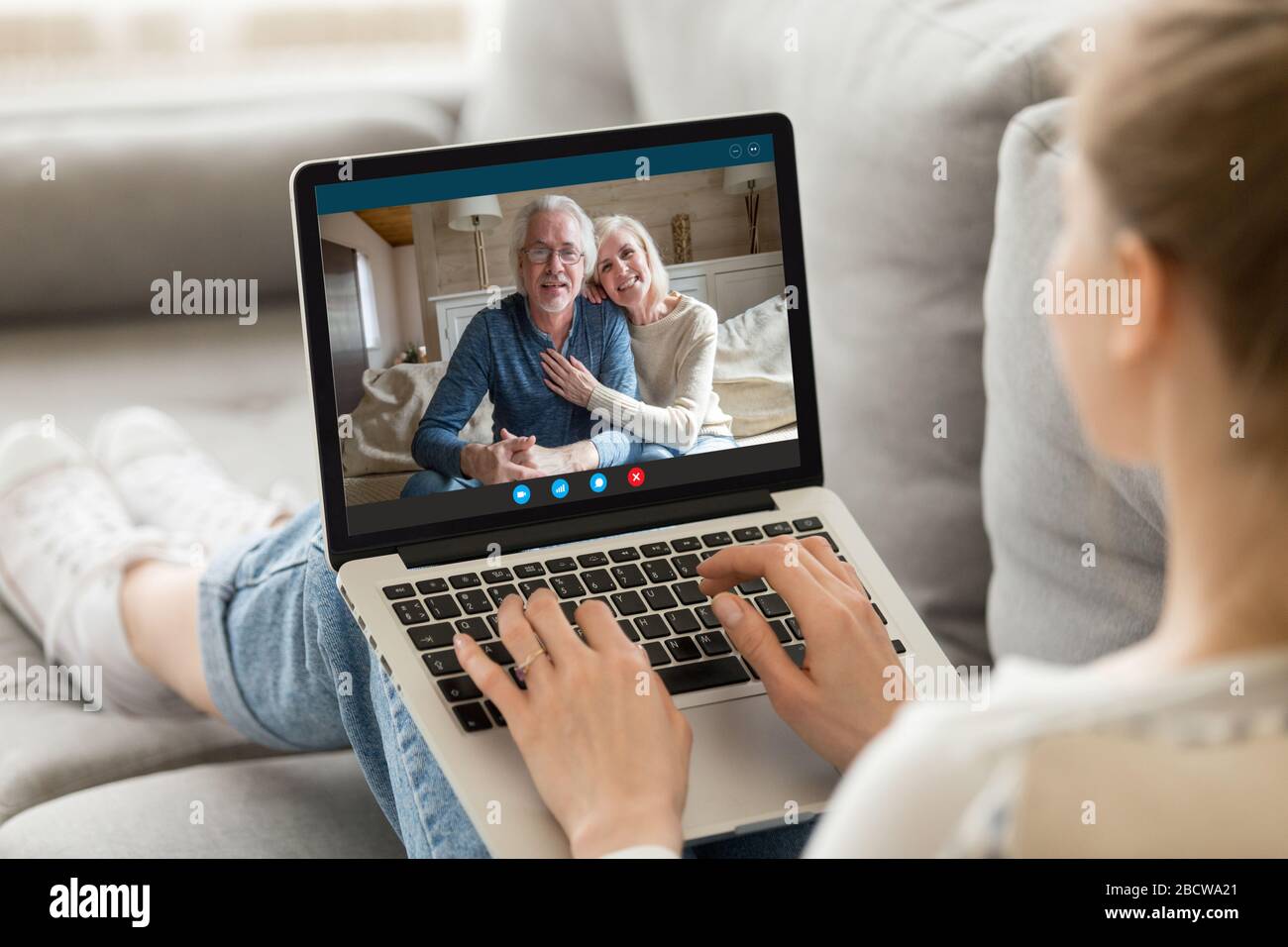 Elderly grandparents communicating with adult granddaughter using video call app Stock Photo