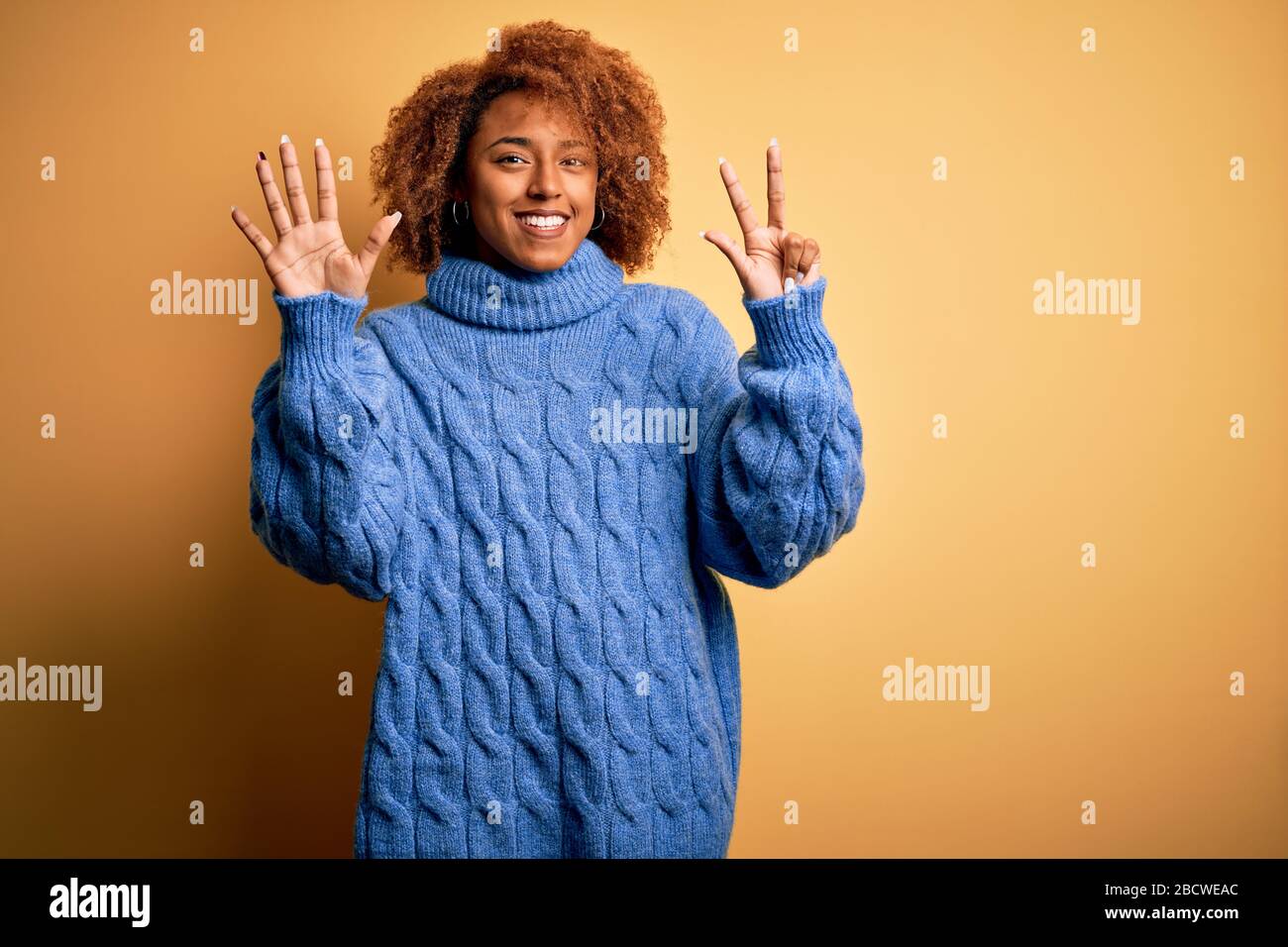 Young beautiful African American afro woman with curly hair wearing ...