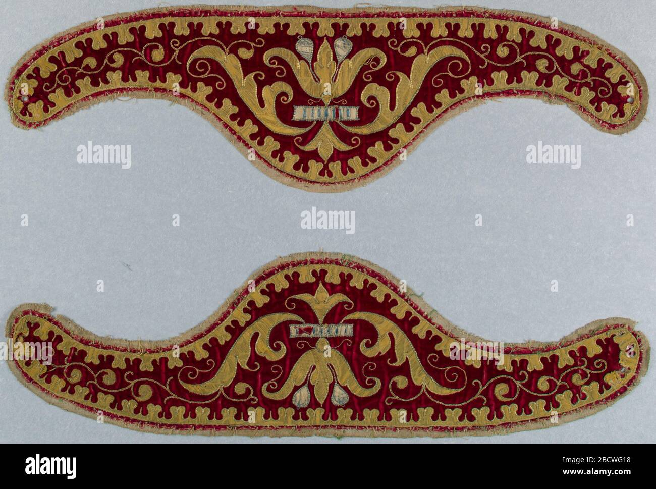 Collars. Research in ProgressTwo apparels (separate collars worn by a priest over the neck of a vestment). Red velvet with applied design in gold cloth outlined with couched gold thread, and white silk with subtle decoration in blue thread. Collars Stock Photo