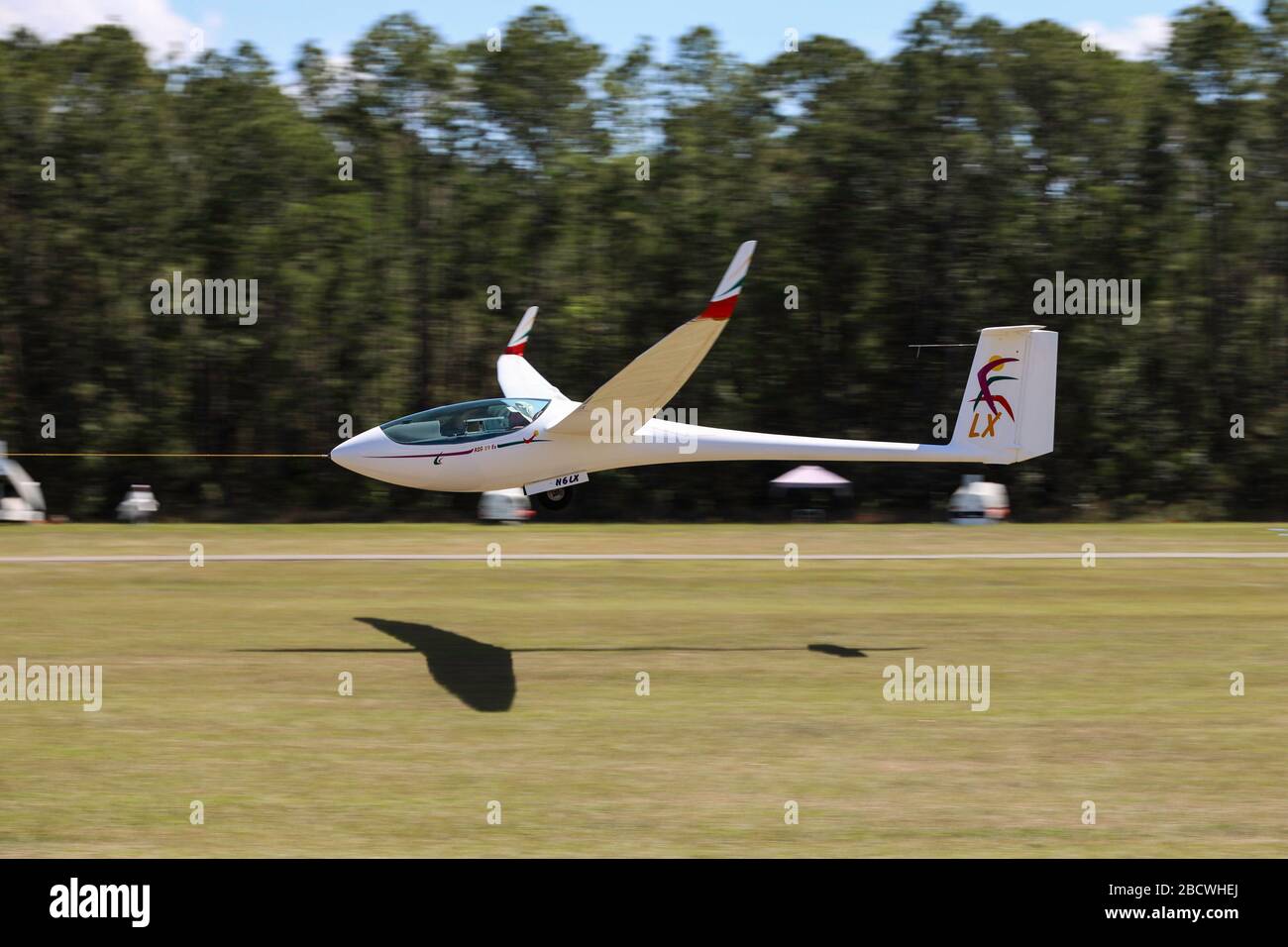 Glider launching in tow behind tractor aircraft Stock Photo Alamy
