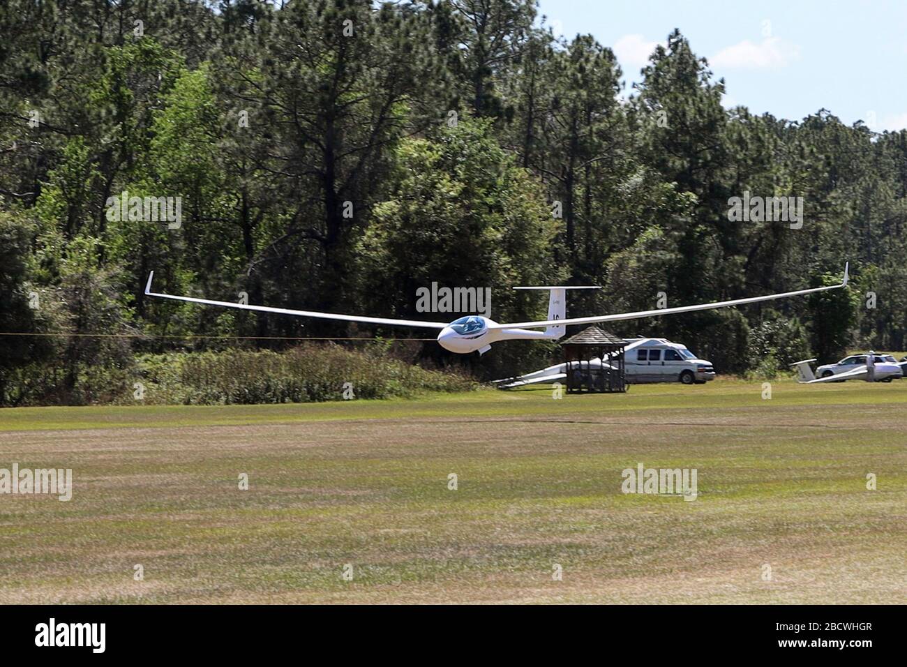 Glider launching in tow behind tractor aircraft Stock Photo Alamy
