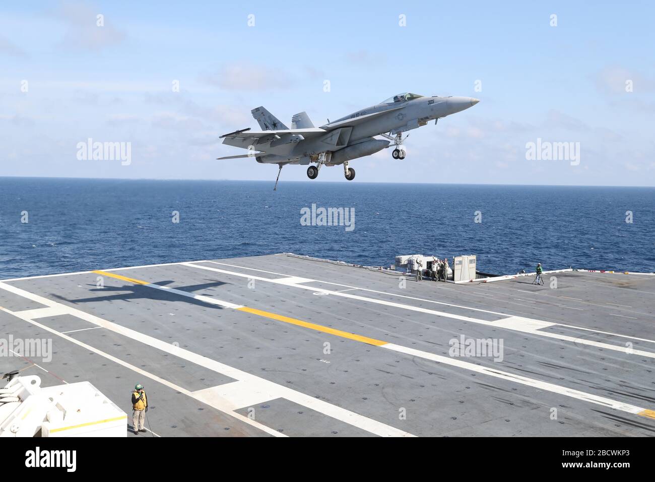 A U.S. Navy F/A-18E Hornet fighter aircraft, attached to Warhawks of Strike Fighter Squadron 97, is waved off as it makes its approach to the flight deck of the Ford-class aircraft carrier USS Gerald R. Ford underway conducting its flight deck and combat air traffic control center certification March 19, 2020 in the Atlantic Ocean. Stock Photo