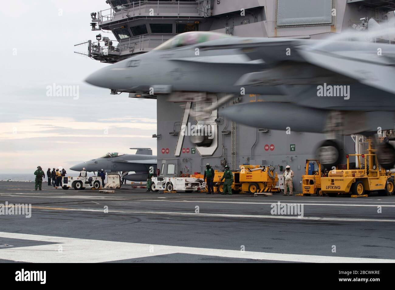 U.S. Navy F/A-18F Super Hornet fighter aircraft, with the Ragin' Bulls of Flight Squadron 37, land on the flight deck of the Ford-class aircraft carrier USS Gerald R. Ford underway conducting its flight deck and combat air traffic control center certification March 23, 2020 in the Atlantic Ocean. Stock Photo