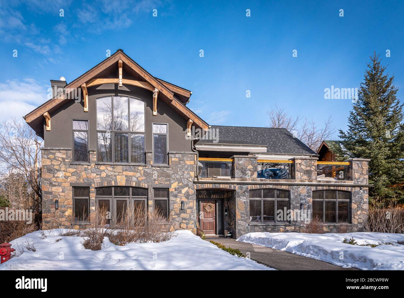 Luxury homes in the mountain town of Canmore Alberta during winter. Canmore is a popular mountain destination in Alberta Canada. Stock Photo