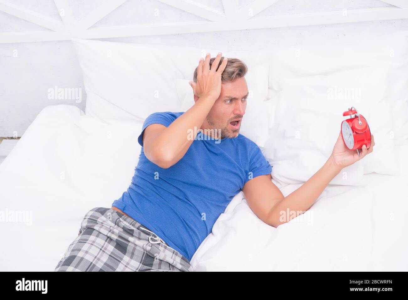 my head is aching. man suffering from headache. terrible loud noise