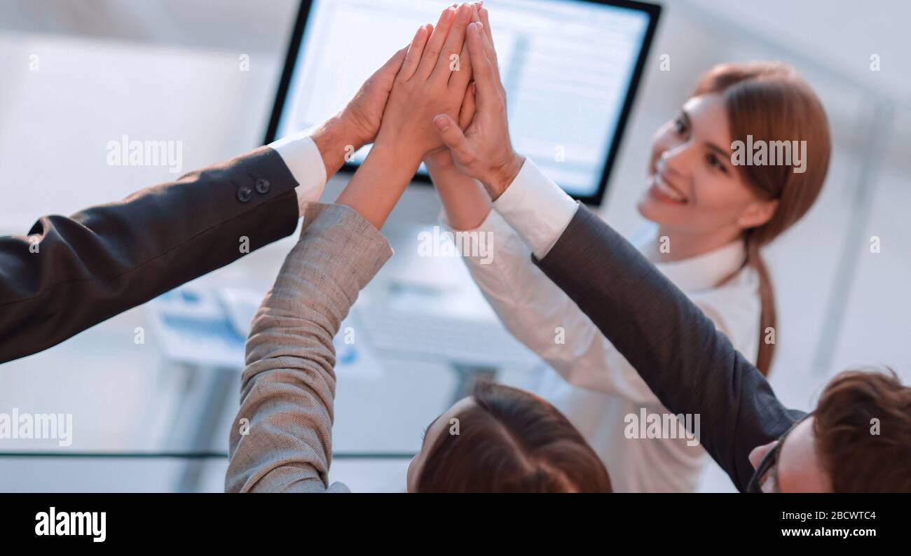 successful business team giving each other a high five Stock Photo - Alamy
