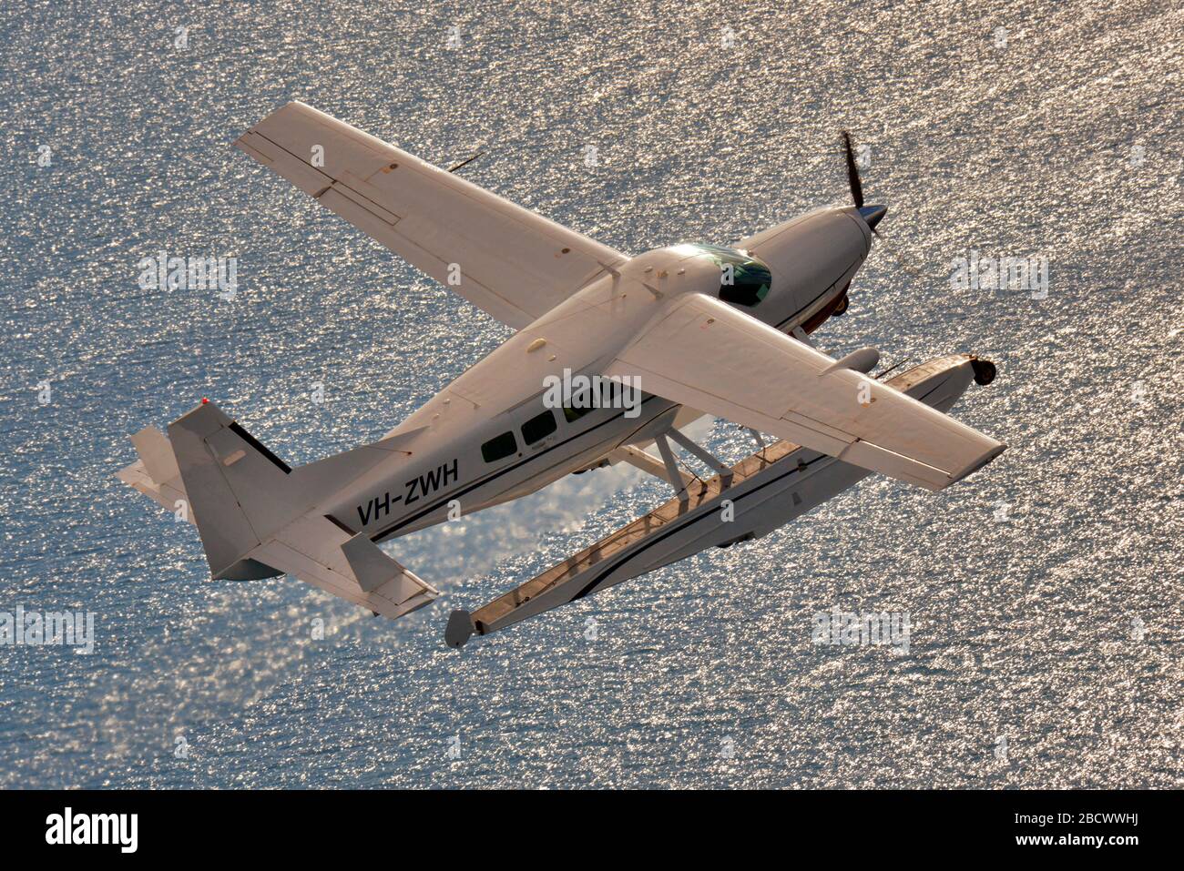 An air-to-air shot of a Cessna 208 Grand Caravan float plane. Stock Photo