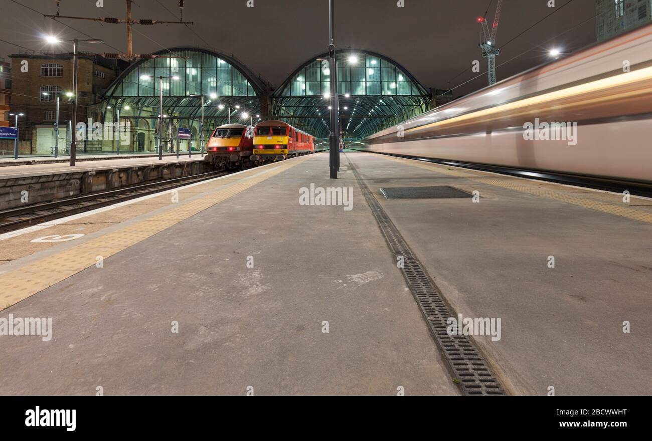 LNER class 91 and DB Cargo class 90 electric  locomotives at London Kings Cross.  90036 and 91138 with early morning departures Stock Photo