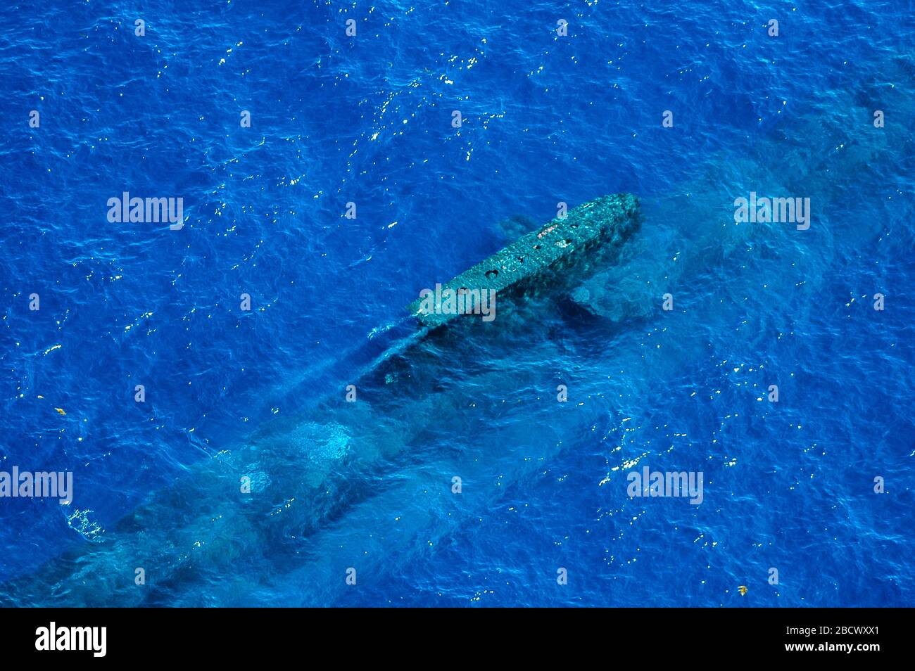An Australian Navy Collins Class submarine is just visible beneath the sea prior to surfacing Stock Photo