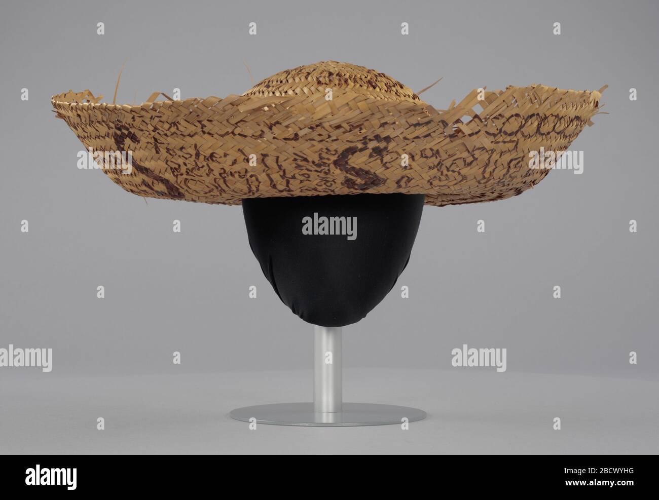Straw sombrero hat associated with Civil Rights campaign Camden Alabama. A woven straw sombrero hat with a rounded crown and wide brim with rolled edges. The ends of some straw pieces are loose on the brim. The hat has writing in brown marker on the crown and underside of the brim. Straw sombrero hat associated with Civil Rights campaign Camden Alabama Stock Photo