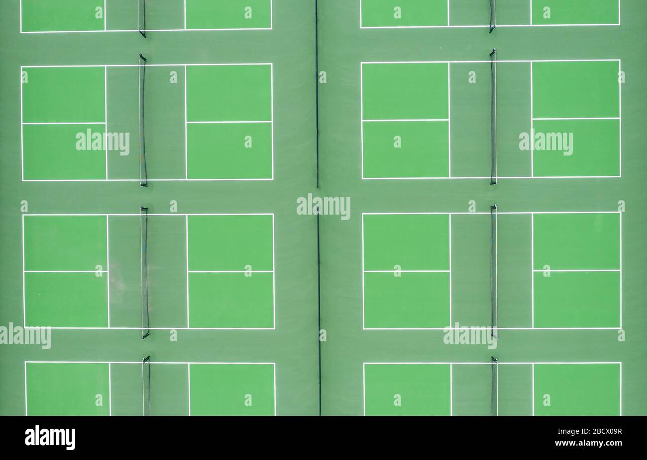 Aerial top down view of community sport center green tennis badminton courts Stock Photo