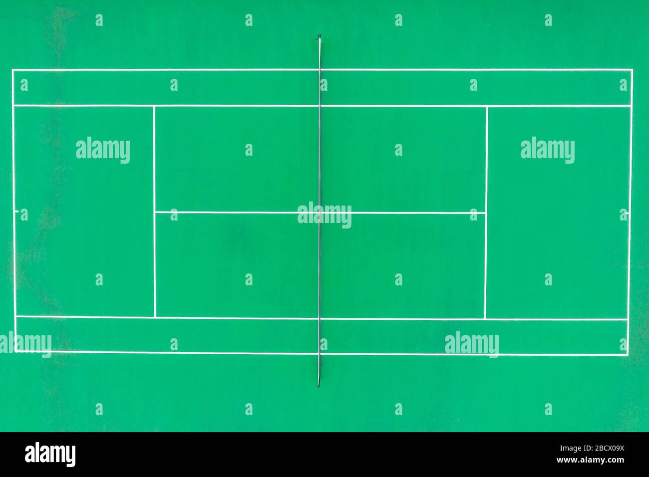 Aerial top down view of tennis court with  green synthetic surface, baseline, singles' sideline, doubles' sideline, net, net posts, center mark, se Stock Photo