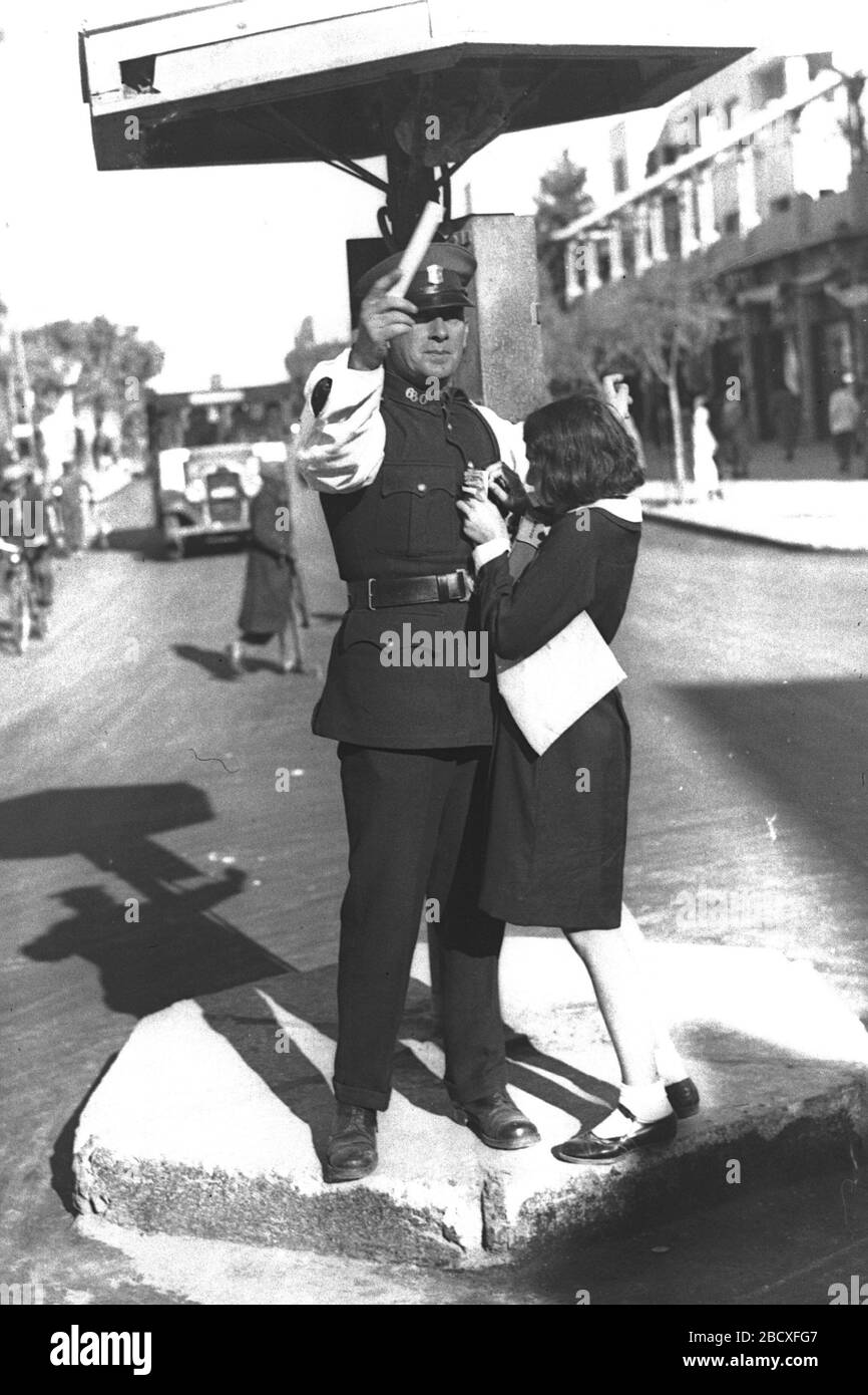 English A High School Girl Pinning A To The Uniform Of A Traffic Policeman On Keren Kayemet Day In Tel Aviv O I U Ss U Ss O O U U O C E U E U E E O E E O U I U O U I I U I E O Ss I U I