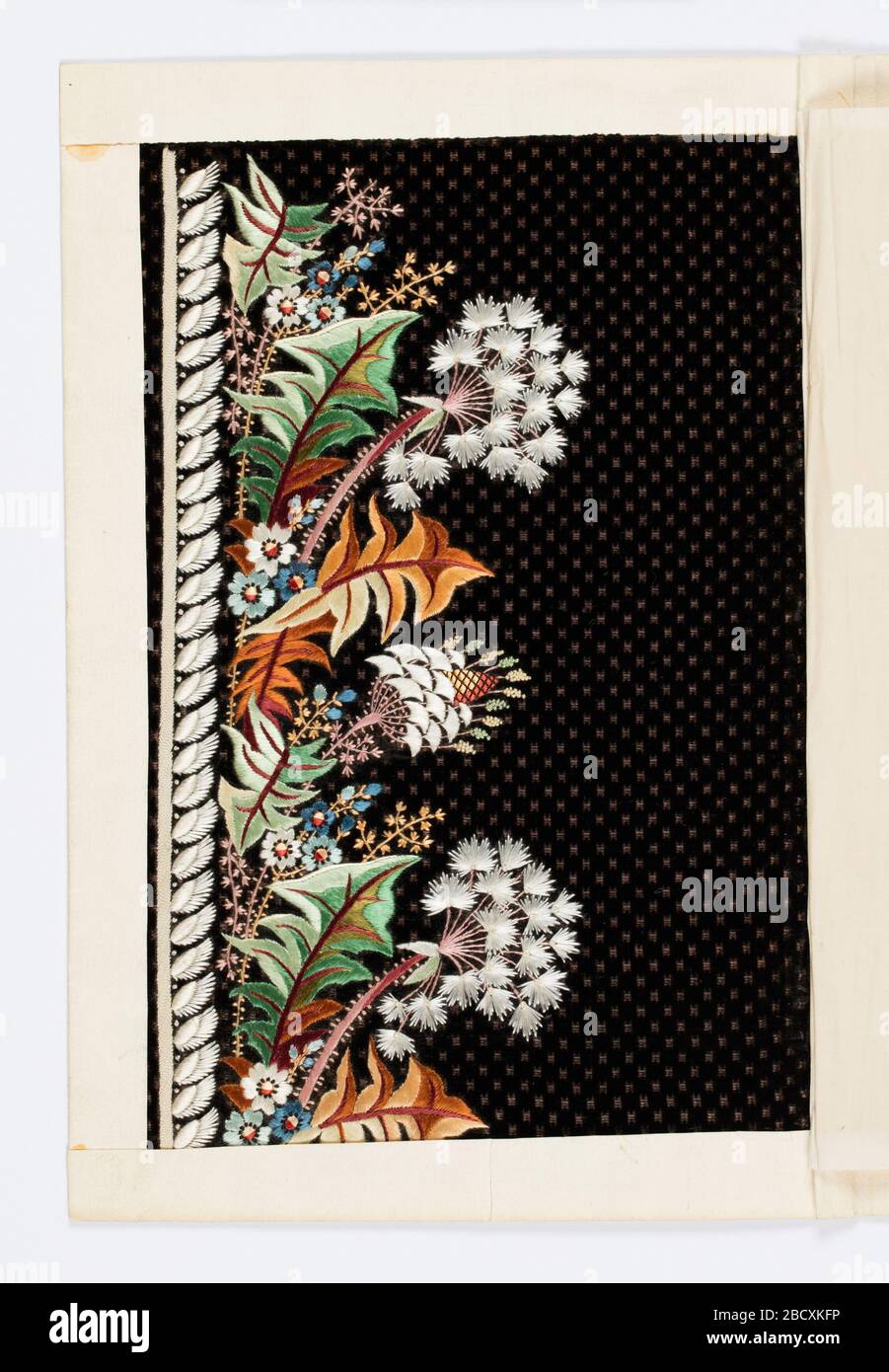 Embroidery sample. Research in ProgressDark purple velvet with minute square dot pattern; embroidered border design in white and brilliant colored silks. Pattern of fantastic foliage and flowers. Embroidery sample Stock Photo