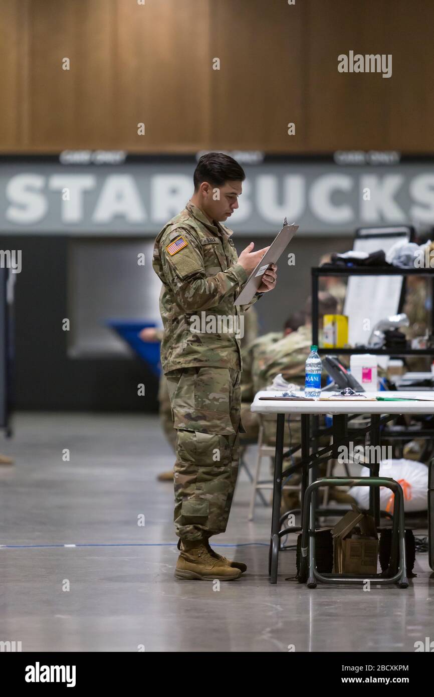 A soldier works to prepare the field hospital in CenturyLink Field Event Center in Seattle on April 5, 2020. The mobile army surgical hospital, currently for non-COVID-19 cases, involves military medical personnel from multiple units, including the Soldiers from the 627th Hospital Center's 10th Field Hospital at Fort Carson, Colorado, the 62nd Medical Brigade from Joint Base Lewis-McChord, Washington and others. Officials said that he hospital is now ready to accept patients. Stock Photo