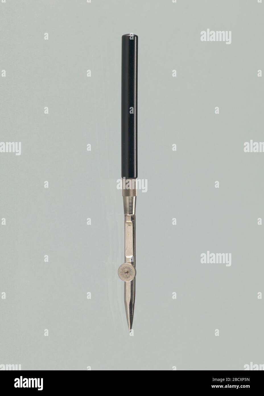 Ruling pen from a drafting took kit used by John S Chase. Ruling pen from a drafting tool kit used by architect John S. Chase. The pen has a black handle. The plastic handle is connected to the metal top with a grooved join. Ruling pen from a drafting took kit used by John S Chase Stock Photo