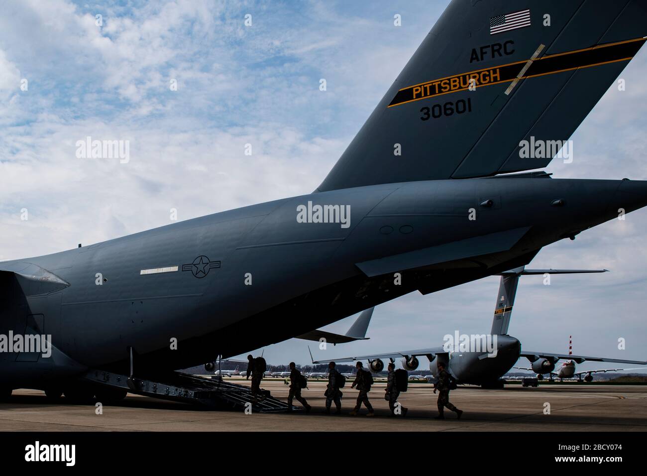 Airmen assigned to the 911th Airlift Wing who were mobilized to support the COVID-19 efforts board onto a C-17 Globemaster III aircraft at the Pittsburgh International Airport Air Reserve Station, Pennsylvania, April 5, 2020. This deployment is part of a larger mobilization package of more than 120 doctors, nurses and respiratory technicians Air Force Reserve units across the nation provided over the past 48 hours in support of COVID-19 response to take care of Americans. (U.S. Air Force photo by Joshua J. Seybert) Stock Photo