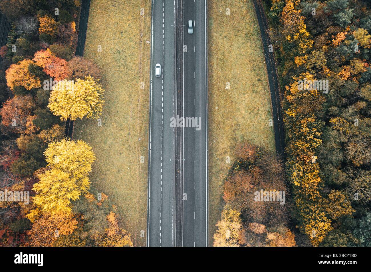 Aerial top down view over dual lane motorway a hazy autumnal day in United Kingdom Stock Photo