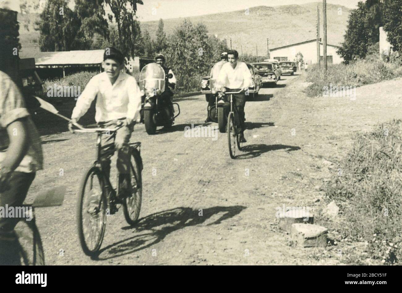 English: A photo of Israel Borochov, a grandson of Ber Borochov,  accompanies Rachel Yanait Ben-Zvi on bicycles, as a fourteen year old kid,  second from left. Kibbutz Ginosar, Israel.; 28 November 1962;