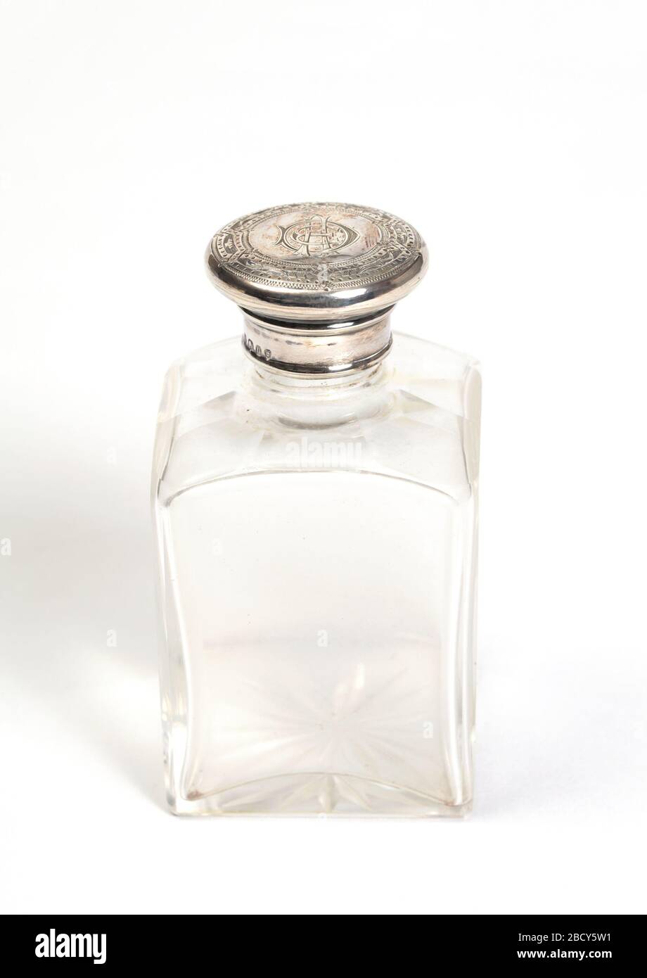 Bottle and cover. Research in ProgressLarger glass bottle with silver top, part of set. Bottle and cover Stock Photo