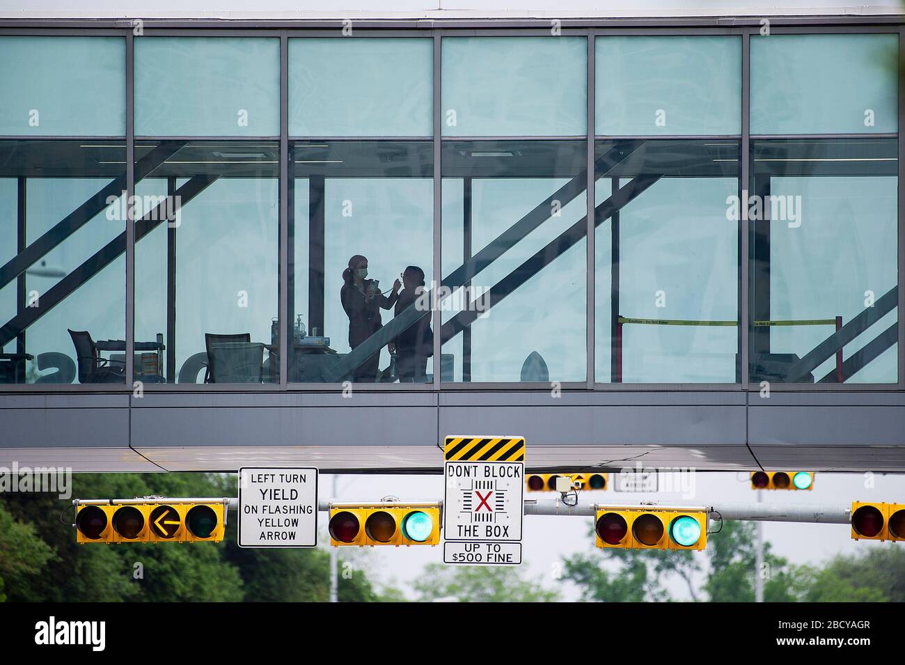 Austin, Texas, USA. 05th Apr, 2020. A person has her temperature taken at an entry station on a footbridge before entering Dell Seton Medical Center at the University of Texas in Austin, Texas. Mario Cantu/CSM/Alamy Live News Stock Photo