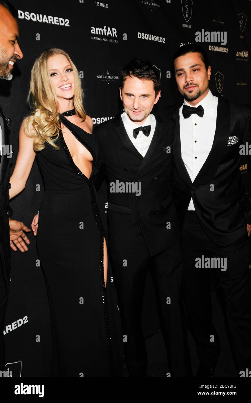 Model Elle Evans (l) and Matthew Bellamy of Muse (c) attend amfAR Official After Party at 1OAK on October 29, 2015 in West Hollywood, California. Stock Photo